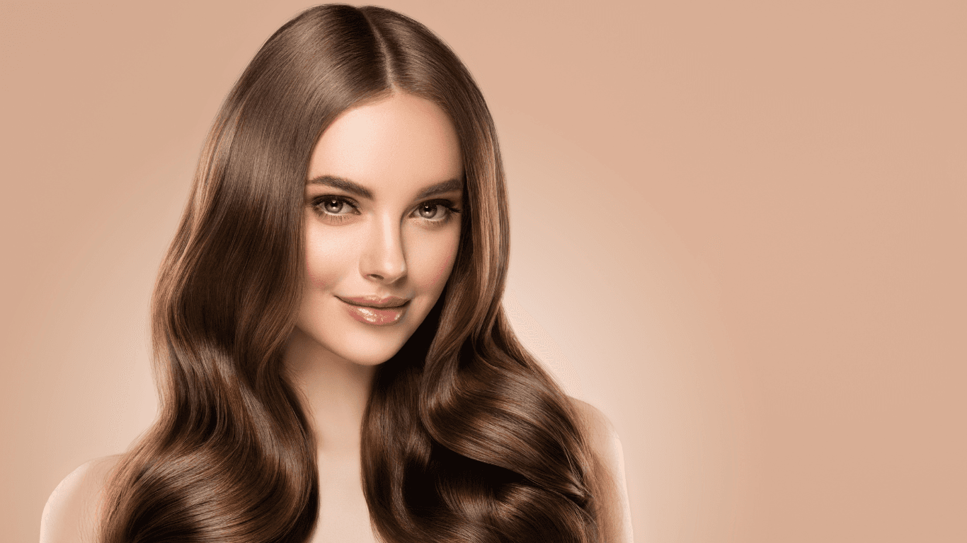 Smiling woman with long, voluminous, bouncy blow-dried hair at Merluza Hair & Beauty in Hall Green, Birmingham